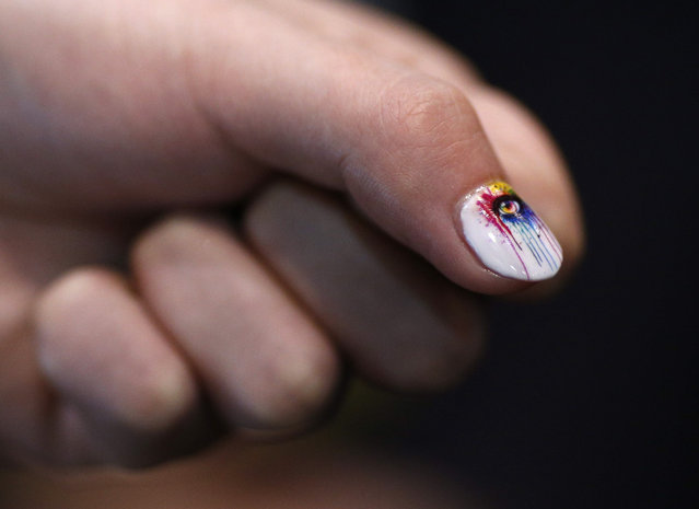 Yihang Shen shows off his nail after demonstrating the Inail Intelligent Printer at CES Unveiled, a media preview event for CES International, Monday, January 4, 2016, in Las Vegas. The device prints directly on finger and toenails as well as fake nails. (Photo by John Locher/AP Photo)