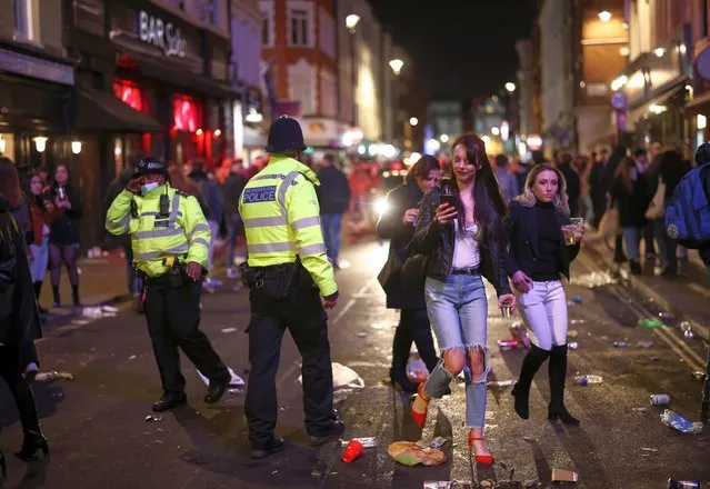 Metropolitan Police patrol as people party at the Soho district, as the coronavirus disease (COVID-19) restrictions ease, in London, United Kingdom on April 16, 2021. (Photo by Henry Nicholls/Reuters)