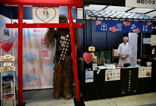 A man dressed up as Chewbacca, a Star Wars character, takes a break next to a Japanese soba noodles shop at Tokyo Comic Con at Makuhari Messe in Chiba, Japan December 2, 2016. (Photo by Issei Kato/Reuters)