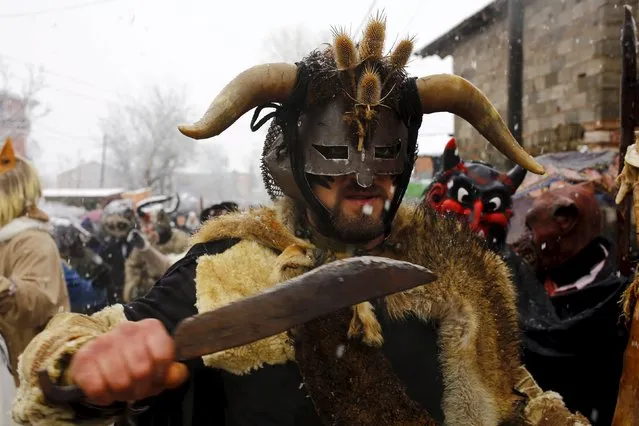 Revellers participate in a parade on the street during a carnival in the village of Vevcani, south of the Macedonian capital of Skopje, January 13, 2016. (Photo by Ognen Teofilovski/Reuters)