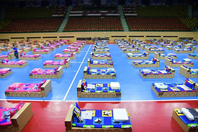 This handout photo from the Thai Ministry of Tourism and Sports taken on April 28, 2021 and released on April 29, 2021 shows the newly setup pre-admission centre equipped with 300 cardboard beds for Covid-19 coronavirus patients at the Nimibutr sports arena in Bangkok, as Thailand struggles to contain a third wave since an outbreak was detected in the capital's nightlife district.  (Photo by Thai Ministry of Tourism and Sports/AFP Photo)