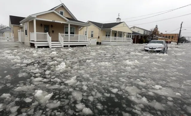 Water and ice floods 12th Ave in North Wildwood, N.J., at the height the storm on Saturday, January 23, 2016. A winter storm created near record high tides along the Jersey Shore, surpassing the tide of Hurricane Sandy according to North Wildwood city officials. (Photo by Dale Gerhard/Press of Atlantic City via AP Photo)