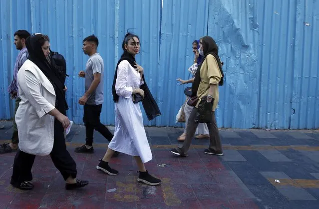 Iranian women, some without the mandatory headscarf, walk in a street in Tehran, Iran, 13 September 2023. Iranians are marking the first anniversary of Mahsa Amini's death which led to nationwide protests over the country's mandatory dress code (Hijab) law. Protests erupted after the death of 22-year old Iranian woman, Mahsa Amini, detained by morality police for not wearing the hijab properly in September 2022. Since then, a growing number of women in the country have been defying authorities by removing the headscarf. (Photo by Abedin Taherkenareh/EPA)