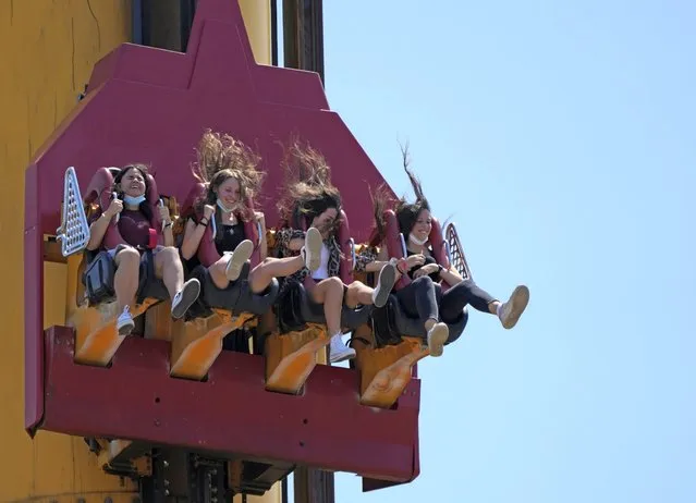 People enjoy a ride at Cinecitta World amusement park in the outskirts of Rome in the day of its reopening, Thursday, June 17, 2021. Amusement parks have been closed since Oct. 25 2020, when Italy's second national lockdown started. (Photo by Alessandra Tarantino/AP Photo)