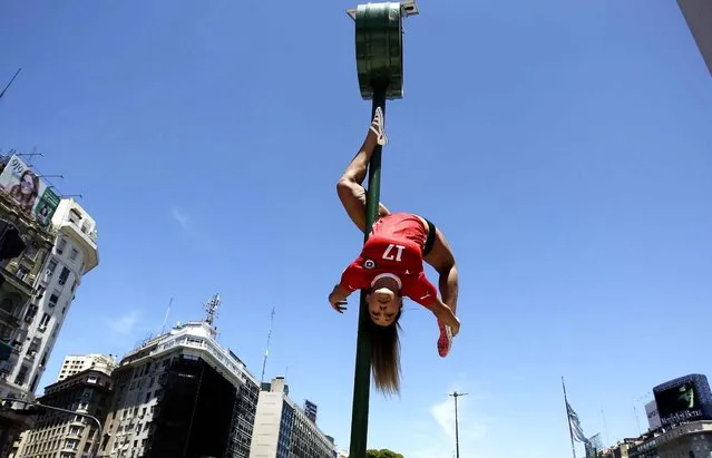 A Chilean participant in the Miss Pole Dance South America 2013 competition performs in in front of the obelisk in Republica Square in downtown Buenos Aires on November 22, 2013 ahead of the contest to be held on November 23 and 25 in the city. (Photo by Juan Mabromata/AFP Photo)