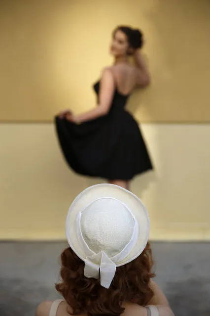 in this April 5, 2015, photo, Sophie Spinelle, foreground, takes pictures of Carey Lynn during the Viva Las Vegas Rockabilly Weekend in Las Vegas. (Photo by John Locher/AP Photo)