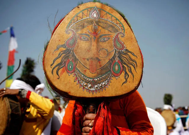 A Tamang shaman holds her drum with a picture of Goddess Maha Kali as she participates during the Sonam Lhosar in Kathmandu, Nepal February 5, 2019. Sonam Lhosar that occurs around the same time as the Chinese New Year marks the New Year of the Pig for the Tamang people, an ethnic indigenous group living in Nepal. (Photo by Navesh Chitrakar/Reuters)