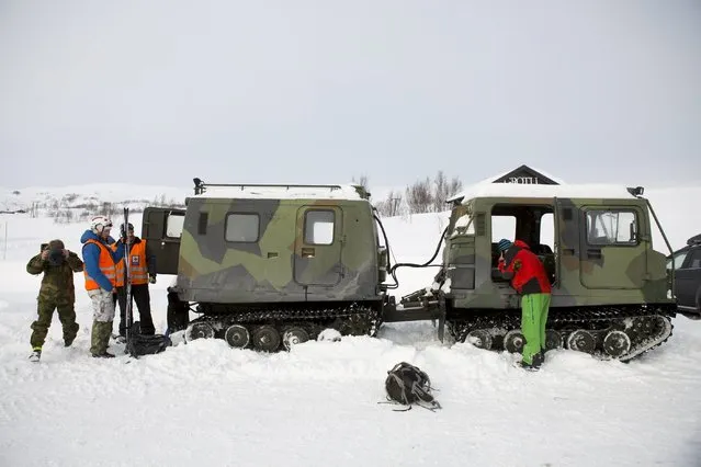 Rescuers stand beside a search and rescue snowcat in Grotli, Norway, February 26, 2016. Thirteen Dutchmen who were stranded while hiking in central Norway's mountains were found after snowmobile patrols by the Red Cross. Snowcats from the Red Cross are now moving ahead to pick the hikers up. (Photo by Torstein Boe/Reuters/NTB Scanpix)