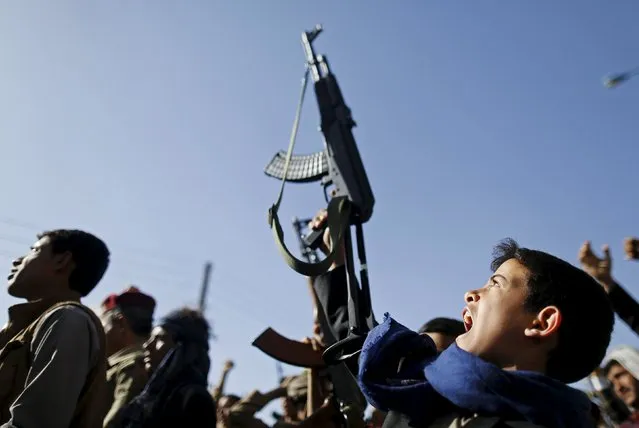 A boy holds up a rifle as he joins followers of the Houthi group demonstrating against the Saudi-led air strikes in Sanaa April 22, 2015. (Photo by Khaled Abdullah/Reuters)