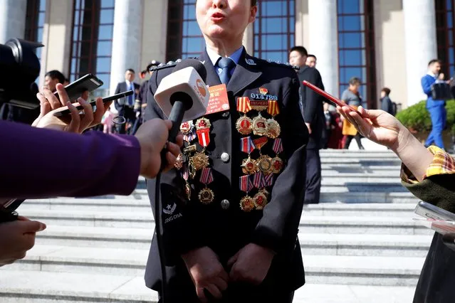 A police delegate speaks to reporters outside the Great Hall of the People after the opening session in Beijing, China on March 5, 2019. (Photo by Aly Song/Reuters)