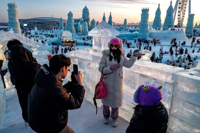 Visitors take photos at the Harbin International Ice and Snow Festival in Harbin, Heilongjiang Province, China, on Wednesday, January 17, 2024. China's deflation was driven by falling prices in its manufacturing sector last year, fresh data showed on Thursday, adding to the risk of trade tensions with the US and Europe amid a major ramp-up in Chinese industrial capacity. (Photo by Andrea Verdelli/Bloomberg)