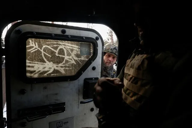 A Ukrainian serviceman of the First Presidential Brigade Bureviy (Hurricane) of the National Guard of Ukraine closes a door of an armoured personnel carrier before evacuation of an injured brother-in-arms from a position in a frontline, amid Russia's attack on Ukraine, near the town of Kreminna, Eastern Ukraine on February 6, 2024. (Photo by Serhii Nuzhnenko/Radio Free Europe/Radio Liberty)