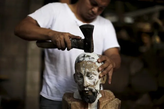 Jose Sabas Gomez's son Miguel Sabas works on a statue of El Jesus Nazareno in his workshop in Apastepeque, El Salvador March 9, 2016. Jose Sabas Gomez is one of a small number of artists still working on traditional religious art in El Salvador. According to him, there used to be more workshops engaged in the work of restoring statues of saints, but only four remain today as the labor-intensive craft is no longer a popular choice of profession. (Photo by Jose Cabezas/Reuters)