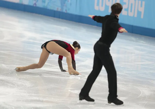 Stefania Berton falls as she and Ondrej Hotarek of Italy compete in the team pairs free skate figure skating competition at the Iceberg Skating Palace during the 2014 Winter Olympics, Saturday, February 8, 2014, in Sochi, Russia. (Photo by Ivan Sekretarev/AP Photo)