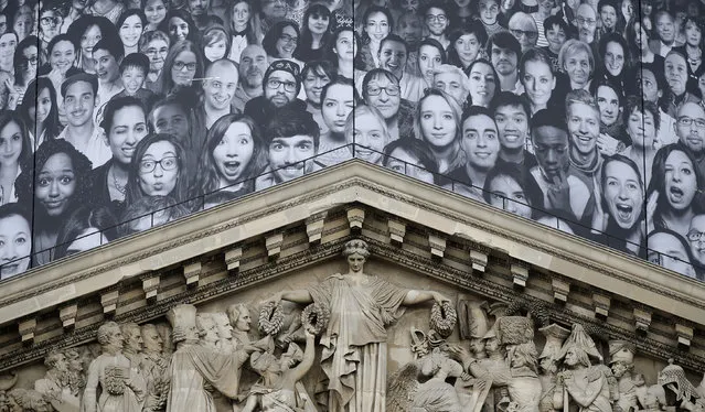 Portraits are displayed on the worksite boarding placed around the dome on the Pantheon during its renovation in Paris, France May 21, 2014. (Photo by Christian Hartmann/Reuters)