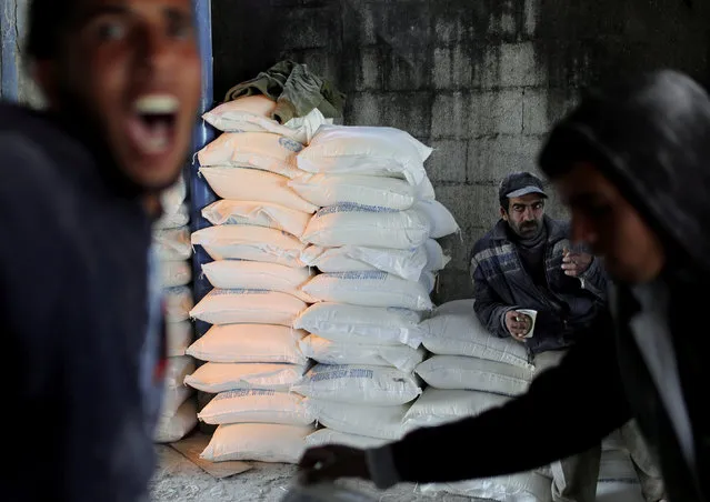 A Palestinian worker rests inside a United Nations food distribution center in Al-Shati refugee camp in Gaza City February 12, 2019. (Photo by Mohammed Salem/Reuters)