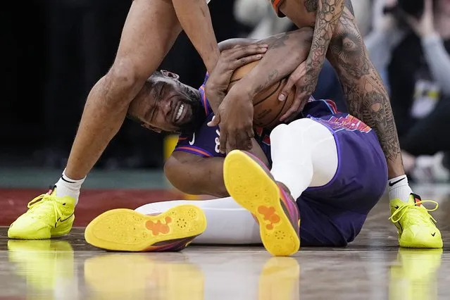 Phoenix Suns forward Kevin Durant, bottom, fights for a loose ball with San Antonio Spurs forward Jeremy Sochan during the second half of an NBA basketball game in San Antonio, Monday, March 25, 2024. (Photo by Eric Gay/AP Photo)