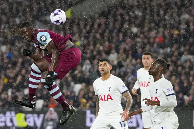 West Ham's Kurt Zouma, left, scores his side's opening goal during the English Premier League soccer match between West Ham and Tottenham, at the London stadium in London, Tuesday, April 2, 2024. (pHOTO BY Kirsty Wigglesworth/AP Photo)