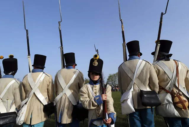 People dressed as Austrian soldiers of the Habsburg dynasty take part in the re-enactment of the battle against Hungary in Tapiobicske, Hungary April 4, 2016. (Photo by Laszlo Balogh/Reuters)