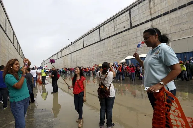 Visitors take pictures during a tour organized by the Panama Canal to the expansion project in Panama City May 17, 2015. Panama Canal Authority hosted a general public tour of the new, expanded locks on the Pacific side of the Panama Canal. Visitors went inside the new locks before they will be filled with water. (Photo by Carlos Jasso/Reuters)
