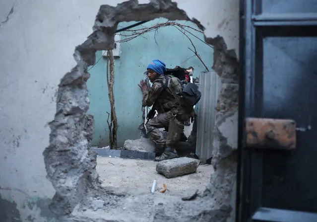 An Iraqi Special Forces soldier moves through a hole as he searches for Islamic State fighters in Mosul, Iraq February 27, 2017. (Photo by Goran Tomasevic/Reuters)