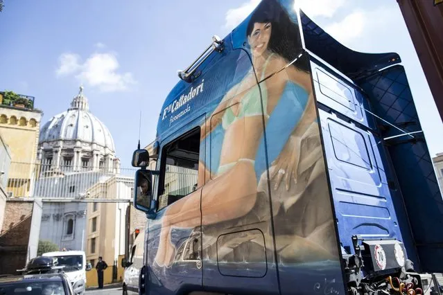 A truck showing a woman dressed with a bikini wait to entry at the Pellegrino check point in Vatican, 11 April 2016. The image of the truck was covered from Vatican workers with a big sheet of paper before the container entered in the Vatican State. (Photo by Massimo Percossi/EPA)
