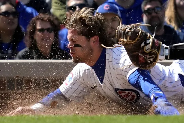 Chicago Cubs' Nico Hoerner is tagged out by Miami Marlins catcher Nick Fortes at home during the fourth inning of a baseball game in Chicago, Sunday, April 21, 2024. (Photo by Nam Y. Huh/AP Photo)