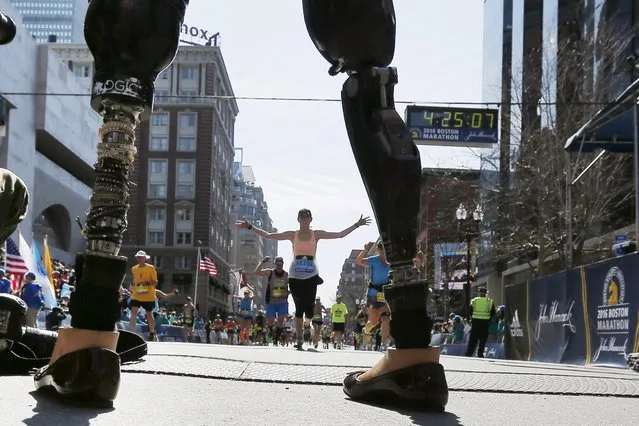 Celeste Corcoran, who lost both her legs in the Boston Marathon bombings, greets runners at they finish the 120th running of the Boston Marathon in Boston, Massachusetts April 18, 2016. (Photo by Brian Snyder/Reuters)