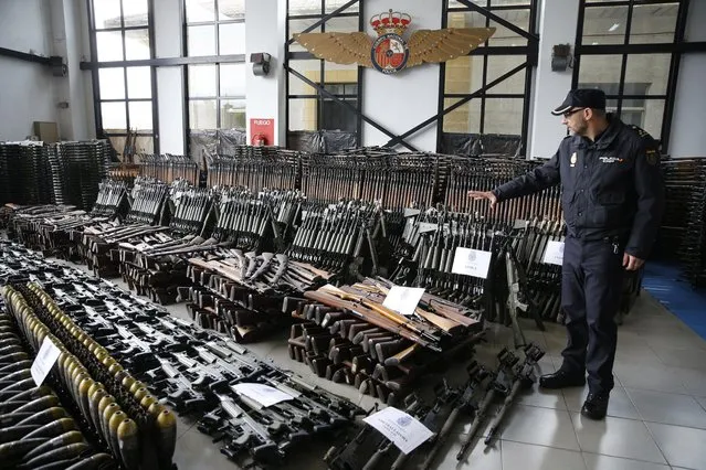 A Spanish National Police spokesman shows weapons seized in January 2017 in the Spanish regions of Bizkaia, Girona and Cantabria, at a police depot in Bilbao, Spain, on 14 March 2017. Up to 10,000 guns, from which 9,000 were CETME Model 58 assault rifles, have been seized by the Spanish National police in three different regions in Spain in an operation carried out together with Europol. The operation originated after the terrorist attack against a Jewish Museum in Brussels back in May 2014. (Photo by Luis Tejido/EPA)