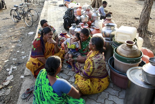 Residents wait with their containers to collect water in Latur, India, April 16, 2016. (Photo by Danish Siddiqui/Reuters)