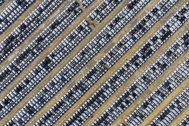 This aerial photograph taken on May 13, 2024 shows Volvo cars waiting to be loaded onto a ship at a port in Nanjing, in eastern China's Jiangsu province. (Photo by AFP Photo/China Stringer Network)