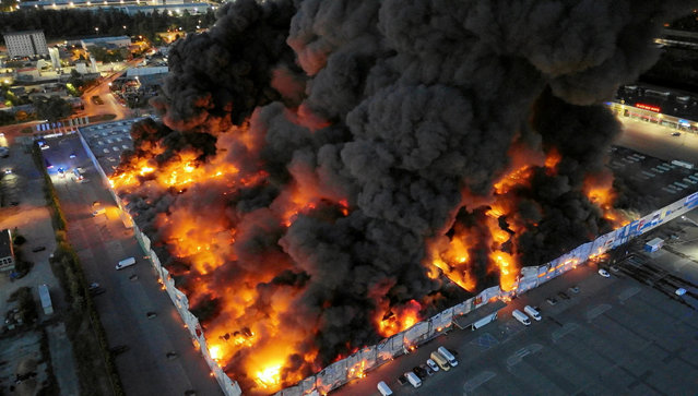 Flames consume the Marywilska 44 shopping centre in Warsaw, Poland on May 12, 2024. (Photo by Dariusz Borowicz/Agencja Wyborcza.pl via Reuters)