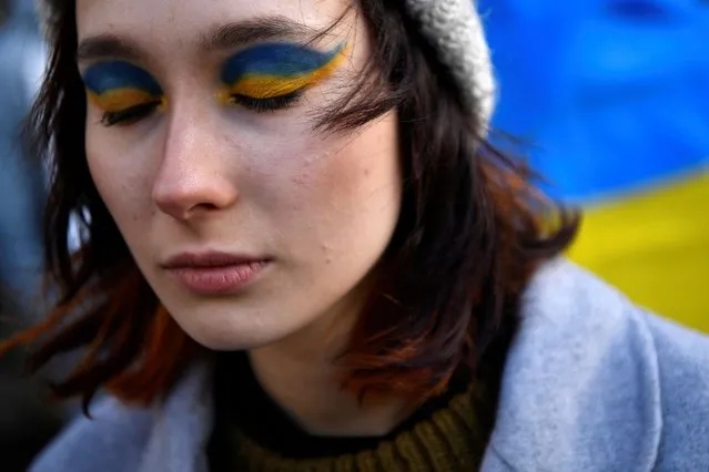 Demonstrator Polina Rant with eyeshadow in the Ukrainian colours, participates in an anti-war protest, after Russian President Vladimir Putin authorised a military operation in Ukraine, in Dublin, Ireland, February 24, 2022. (Photo by Clodagh Kilcoyne/Reuters)
