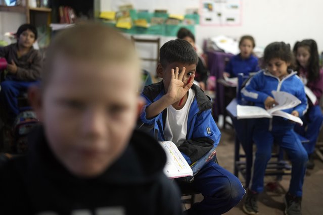 Third graders attend class inside a building at the New Asuncion school in Presidente Hayes in Paraguay's Chaco region, Monday, June 3, 2024. Due to not enough classrooms, students have been attending classes outside for the past three years with instruction from a municipal worker. (Photo by Jorge Saenz/AP Photo)