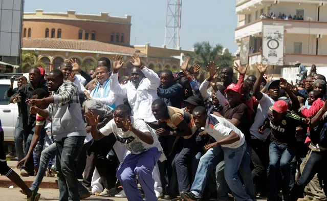 Democratic Republic of Congo's opposition Presidential candidate Moise Katumbi and his supporters react as riot police fire teargas at them as they walk to the prosecutor's office over government allegations he hired mercenaries in a plot against the state, in Lubumbashi, the capital of Katanga province of the Democratic Republic of Congo, May 13, 2016. (Photo by Kenny Katombe/Reuters)