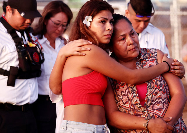 Adelina (R) and Alondra Gonzalez, whose loved one Juan de Leon died in the fire, embrace at the “Tear Drop Memorial” honoring victims of the Lahaina wildfire on August 7, 2024 in Lahaina, Hawaii. August 8 marks the one-year anniversary of the Maui wildfires which killed 102 people and devastated the historic community of Lahaina in West Maui. (Photo by Mario Tama/Getty Images)