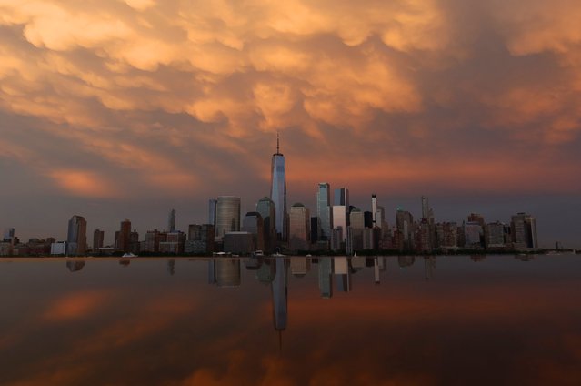 Mammatus clouds pass over the lower Manhattan skyline and One World Trade Center as the sun sets in New York City on August 4, 2024, as seen from Jersey City, New Jersey. (Photo by Gary Hershorn/Getty Images)