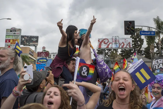 Women kiss in defiance of hateful speech from provocative street preachers at the #ResistMarch during the 47th annual LA Pride Festival on June 11, 2017, in the Hollywood section of Los Angeles and West Hollywood, California. Inspired by the huge womenÕs marches that took place around the world following the inauguration of President Donald Trump and by the early pride demonstrations of the 1970s, LA Pride replaced its decades-old parade with the #ResistMarch protest to promote human rights by marching from Hollywood to West Hollywood. (Photo by David McNew/Getty Images)