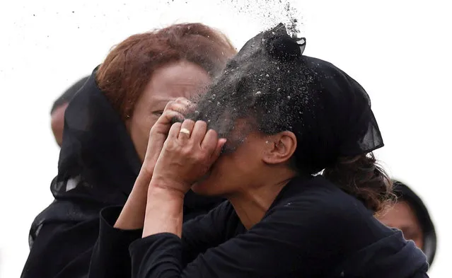 A relative puts soil on her face as she mourns at the scene of the Ethiopian Airlines Flight ET 302 plane crash, near the town Bishoftu, near Addis Ababa, Ethiopia on March 14, 2019. (Photo by Tiksa Negeri/Reuters)