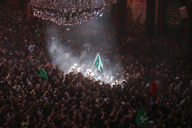 Shiite Muslims take part in ceremony during the peak of Ashura, a 10-day period commemorating the seventh century killing of Prophet Mohammed's grandson Imam Hussein, at the shrine of Imam Hussein in Iraq's holy city of Karbala, on July 17, 2024. (Photo by Mohammed Sawaf/AFP Photo)