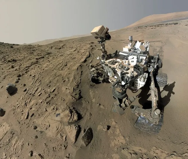 A handout picture released by NASA on 25 June 2014 shows a composite image of NASA's Mars rover Curiosity. The rover used the camera at the end of its arm in April and May 2014 to take dozens of component images combined into this self-portrait where the rover drilled into a sandstone target called 'Windjana.' (Photo by EPA/NASA/JPL-Caltech/MSSS)