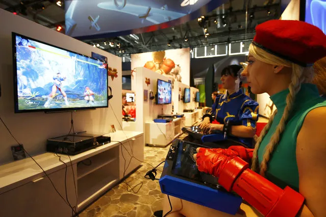 Two women, dressed as videogame Streetfighter's characters Chun-Li and Cammy (R), play the game on a Sony playstation during the Gamescom 2015 fair in Cologne, Germany August 5, 2015. (Photo by Kai Pfaffenbach/Reuters)