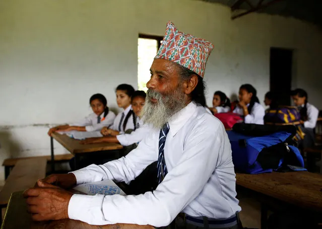 Durga Kami, 68, who is in the tenth grade at Shree Kala Bhairab Higher Secondary School, attends a class in Syangja, Nepal, June 5, 2016. (Photo by Navesh Chitrakar/Reuters)