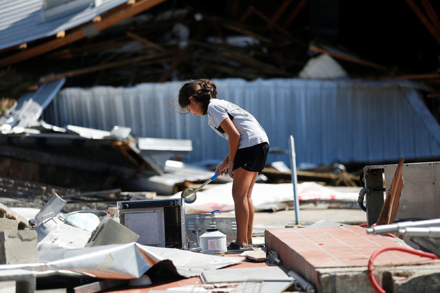 Kyla Williams, daughter of a manager at Roy’s Restaurant, helps cleaning after Hurricane Helene made landfall overnight, in Steinhatchee, Florida on September 27, 2024. (Photo by Octavio Jones/Reuters)