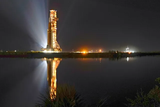 The NASA Artemis rocket with the Orion spacecraft aboard leaves the Vehicle Assembly Building moving slowly to pad 39B at the Kennedy Space Center, Monday, June 6, 2022, in Cape Canaveral, Fla. While at the pad the rocket and Orion spacecraft will undergo tests to verify systems and practice countdown procedures. (Photo by John Raoux/AP Photo)