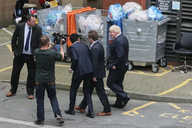 British Member of Parliament, Boris Johnson, speaks with a video crew as he leaves Westminster Tower in Lambeth, Friday, June 24, 2016. Britain voted to leave the European Union after a bitterly divisive referendum campaign, according to tallies of official results Friday. (Photo by Tim Ireland/AP Photo)