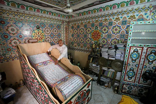 Saad Mohammed rolls down what he says is the largest handwritten version of Koran in the world measuring around 700 meters long, the town of Belqina, north of Cairo, Egypt, April 26, 2017. (Photo by Abd El Ghany/Reuters)