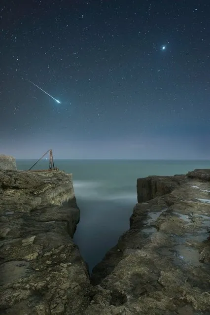 “Shooting Star and Jupiter”, Rob Bowes (UK). A shooting star flashes across the sky over the craggy landscape of Portland, Dorset, as our neighbouring planet Venus looks on. The image is of two stacked exposures: one for the sky and one for the rocks. (Photo by Rob Bowes/National Maritime Museum/The Guardian)
