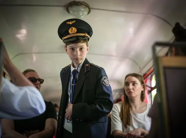 A child conductor on the Kyiv Children's Railway in Syretsky Park strictly ensures that passengers remain seated and oversees their safety on June 04, 2022 in Kyiv, Ukraine. The Children's Railway in Kyiv has reopened for visitors after the Russian invasion of Ukraine. Children's railways were popular in the former USSR and were established for children and teenagers to learn the trades of the extensive Soviet rail network and to move on to employment within the netwrok. A sense of normality has increasingly returned to Kyiv as Russia's assault has focused on the eastern Donbas region. (Photo by Christopher Furlong/Getty Images)