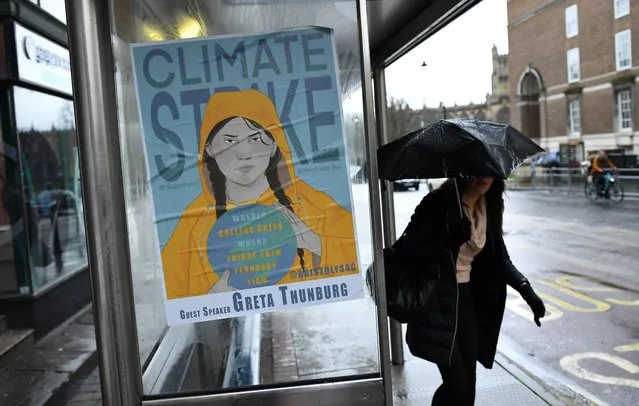 A woman walks next to a banner, ahead of a youth climate protest in Bristol, Britain, Britain on February 28, 2020. (Photo by Dylan Martinez/Reuters)